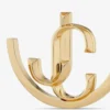 Aros Jc Monogram de metal con acabado dorado Aros Jc Monogram Aros Jc Monogram de metal con acabado dorado Aros Jc Monogram