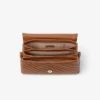 Bolso Curve Top Handle de piel Biker acolchada en color tostado con detalle de perlas