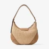 Bolso de hombro Bar Hobo pequeño de rafia natural y color toffee con ribetes de piel de becerro lisa Bolso de hombro Bar Hobo pequeño de rafia natural y color toffee con ribetes de piel de becerro lisa