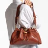 Bolso de hombro mediano Cinch en piel estampada de elaphe color coñac con costuras de cuero estilo Biker