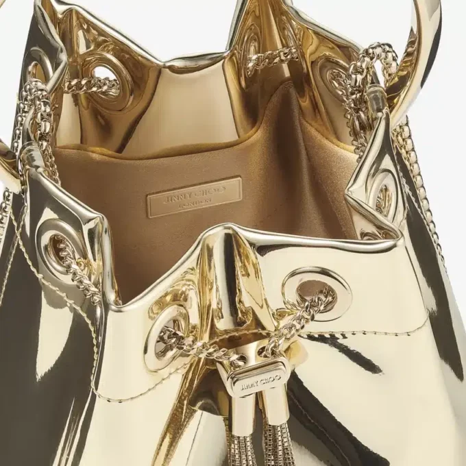 Bolso mini Bon Bon de tela dorada espejada con asa metálica
