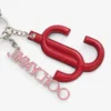 Colgante Jc Multi Charm de piel de becerro en rojo y rosa caramelo con logotipo de estrella Colgante Jc Multi Charm de piel de becerro en rojo y rosa caramelo con logotipo de estrella