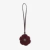 Dije de flor de punto Dije de flor de lana de punto en color merlot intenso con ribetes de cuero