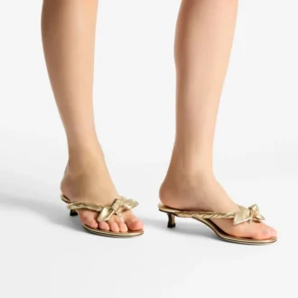 Sandalias tipo mule Liss 35 de piel napa metalizada dorada con lazo
